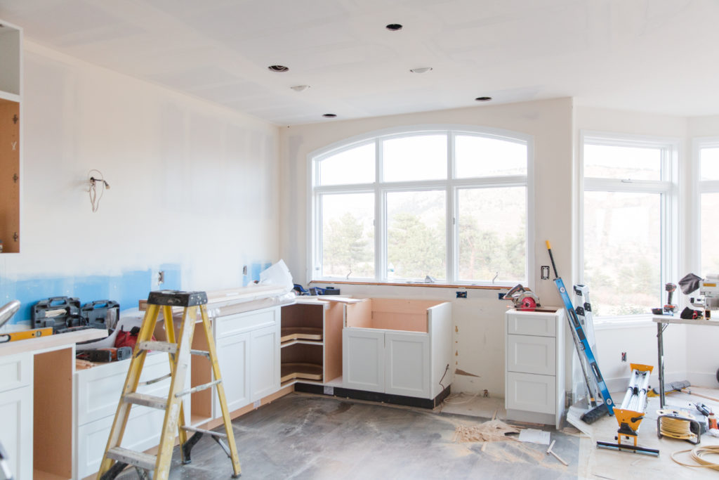 Renovated Kitchen with unfinished drywall and installing new appliances