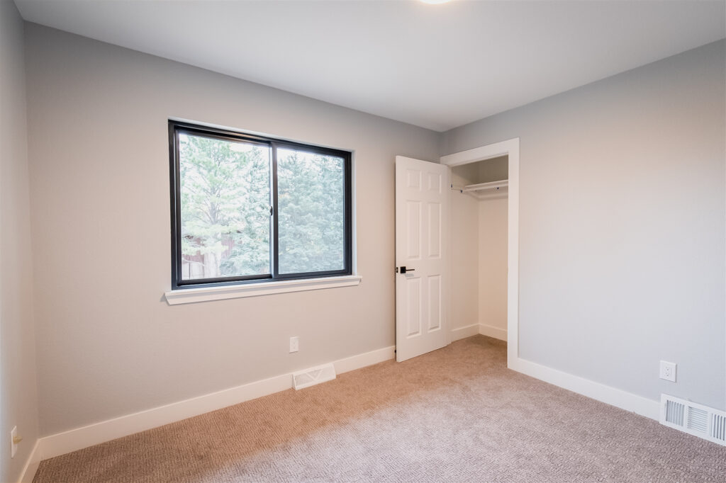 Newly remodeled room in a Colorado home, featuring new windows and closet.